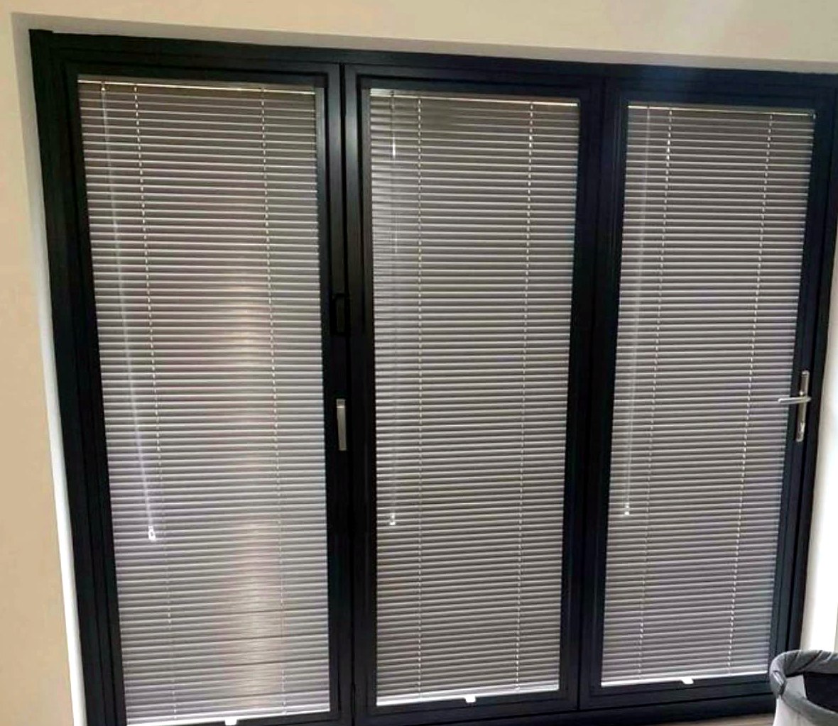 Perfect fit venetian blinds fitted to each glass panel of anthracite grey bifold doors